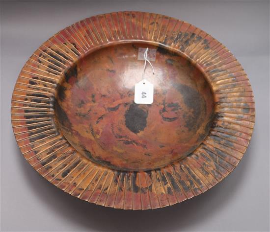 A large circular patinated copper dish, impressed S.F. to foot rim, diameter 44.5cm